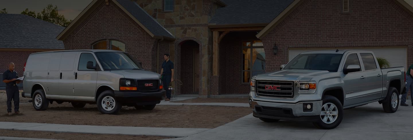 A couple of trucks parked in a construction field.