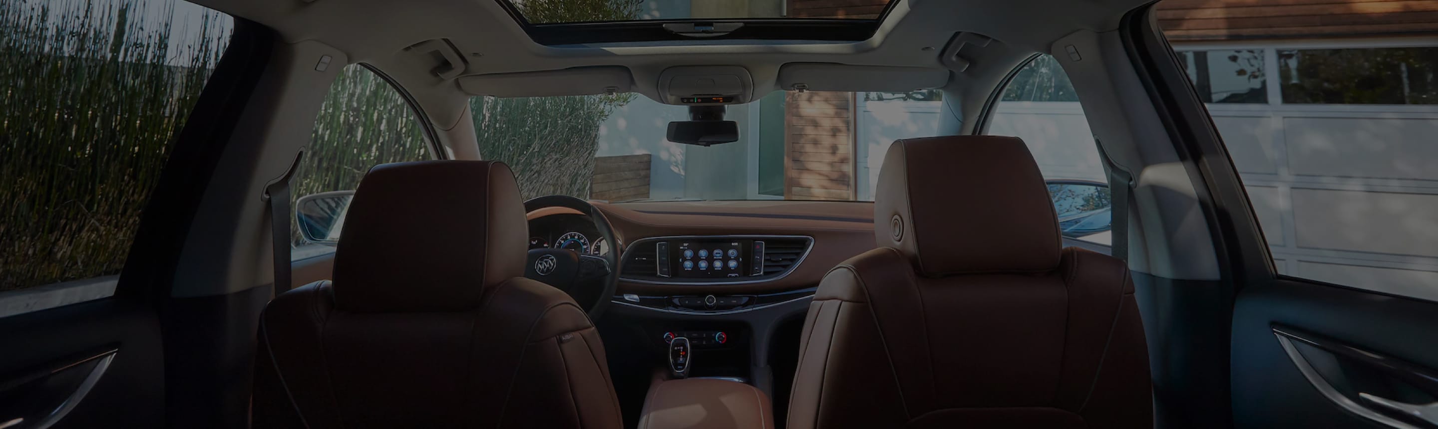 A front interior view of a Buick vehicle from the backseat