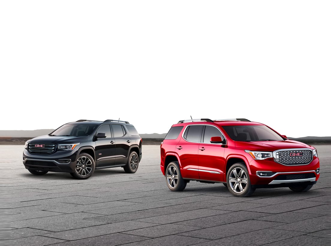 Two GMC vehicles, a red and a black one.