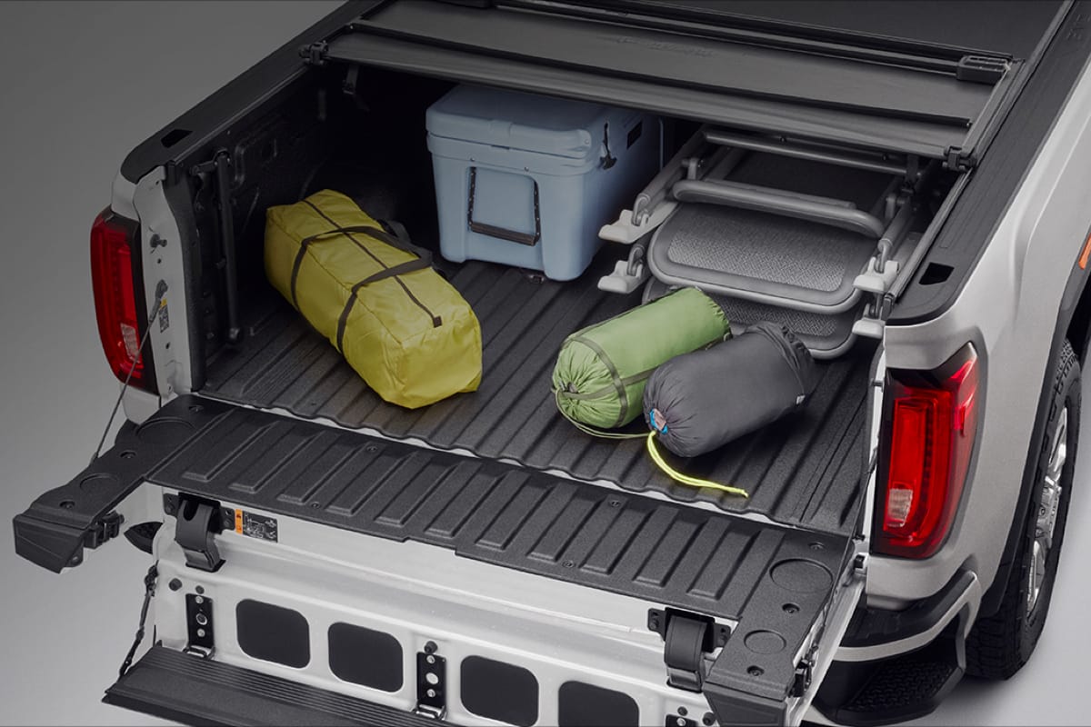 A GMC trunk filled with accessories & floor mats