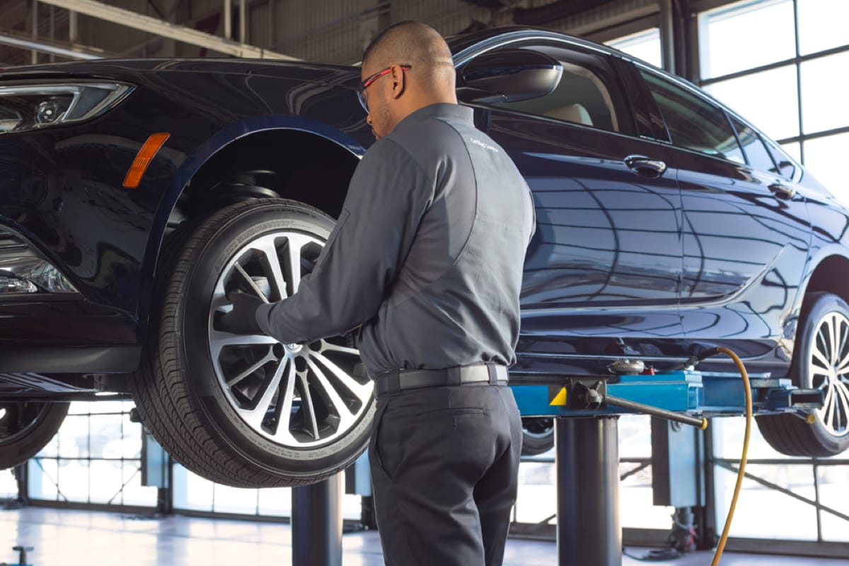 A service technician installing a tire