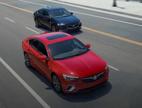 Two moving Buick vehicles.