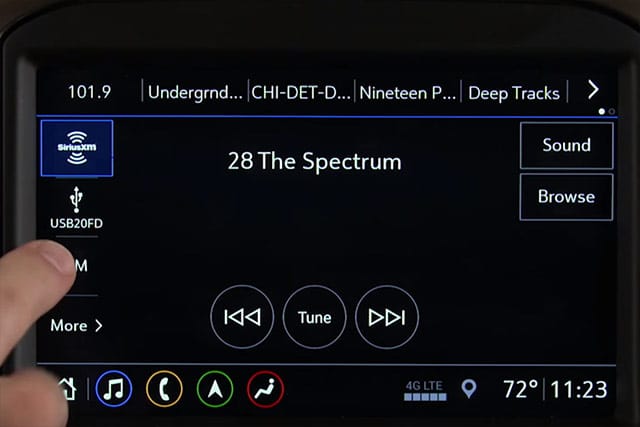 User interacting with touchscreen infotainment system in vehicle