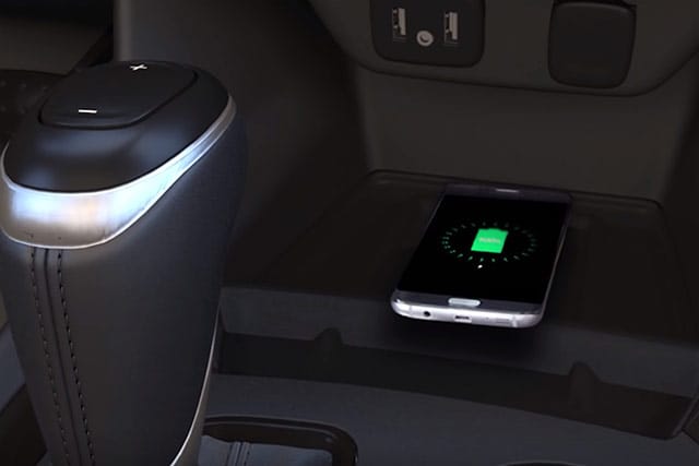 Phone resting on vehicle's wireless charging pad